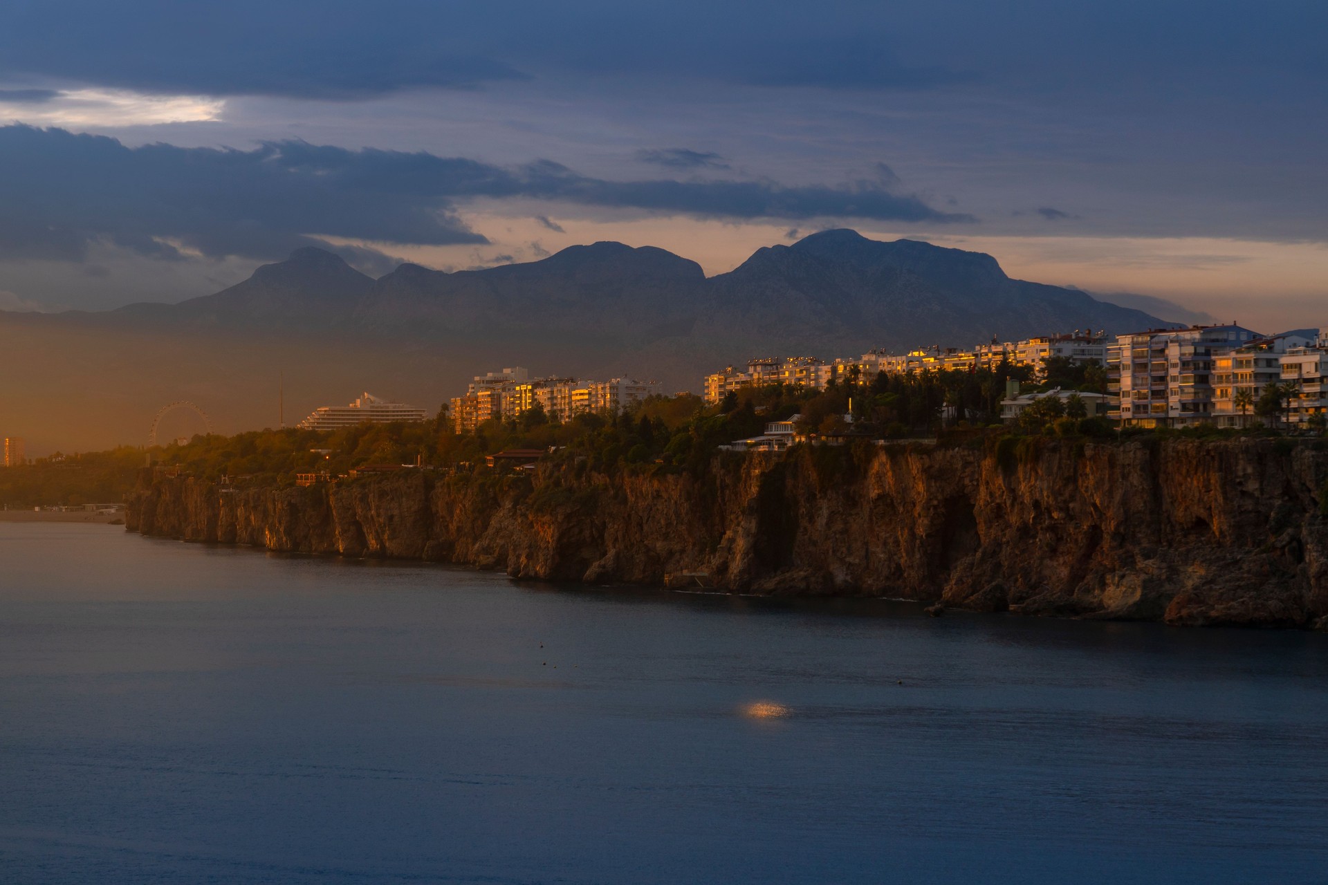Sunset at Famous old city in Antalya with Konyaaltı beach and Bay mountains.